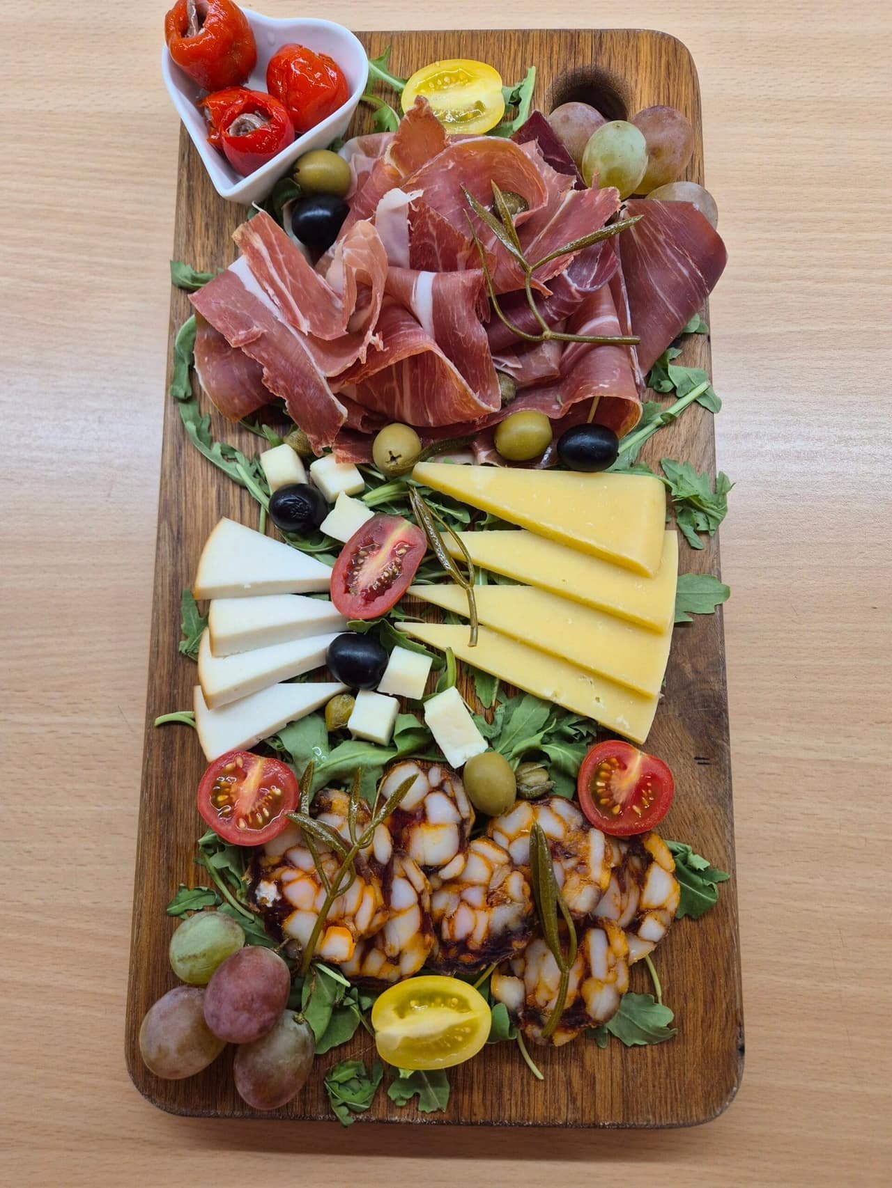 Cheese and pršut board with olives and tomato