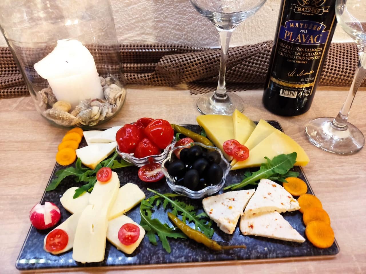 Cheese plata with wine, olives and dried fruit