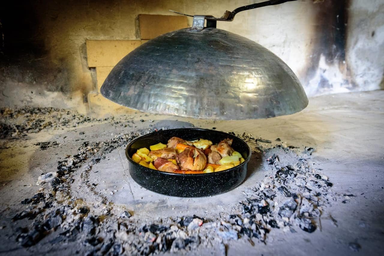 The iron bell lifted from the embers
